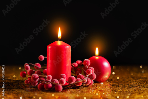 Obraz na płótnie Two red Christmas candles on a dark background w salonie