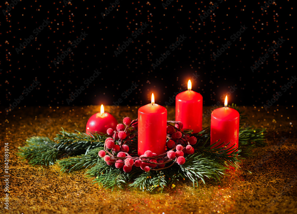 Four red Christmas candles on a dark background