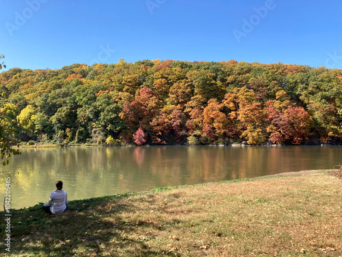 Woman meditating in Inwood Hill Park photo