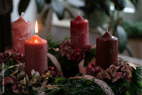 Traditioneller Adventskranz mit brennender erster Kerze zum 1. Advent photo