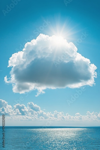 A tranquil view of blue ocean waters under a large white cloud on a clear sun...