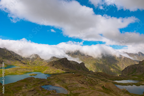 Lakes on the top of mountains and rolling clouds over the mountains. photo