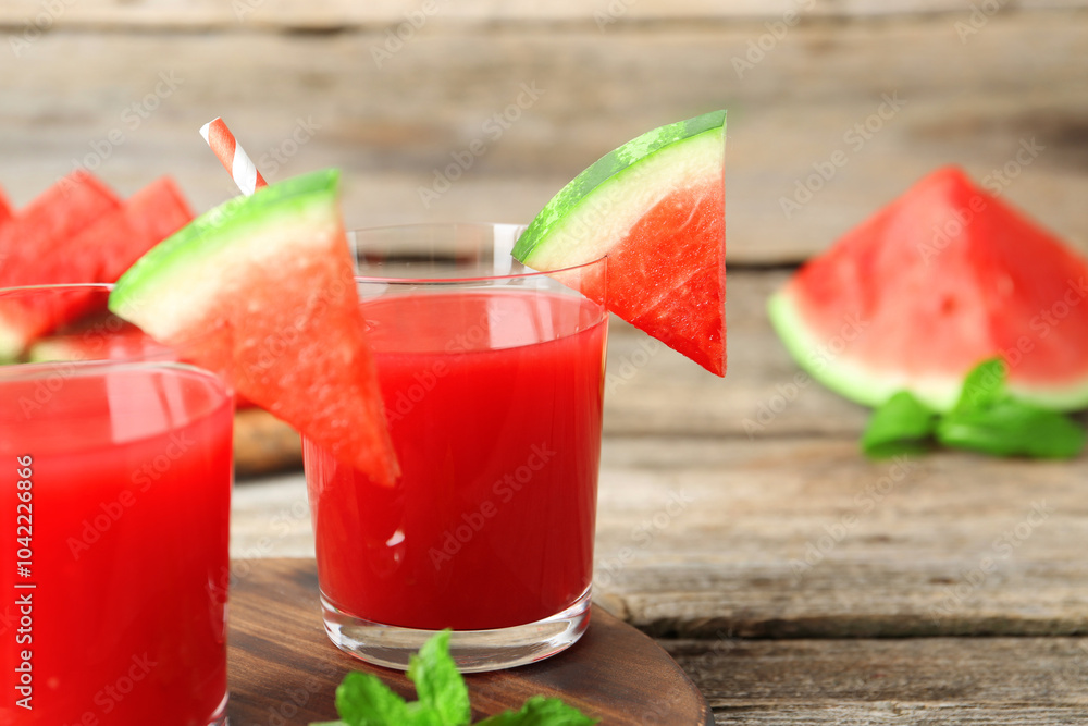 Tasty watermelon drink in glasses, fresh fruit and mint on wooden table, closeup Tasty watermelon drink in glasses, fresh fruit and mint on wooden table, closeup