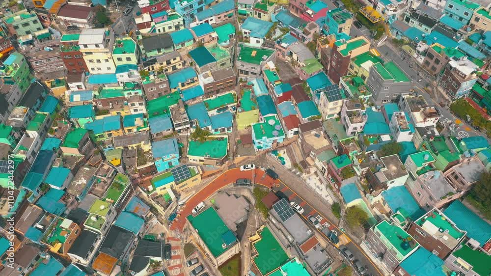 BUSAN, SOUTH KOREA - OCTOBER 19, 2024: Aerial view of vibrant blue rooftops in a bustling neighborhood filled with lively streets and cars BUSAN, SOUTH KOREA - OCTOBER 19, 2024: Aerial view of vibrant blue rooftops in a bustling neighborhood filled with lively streets and cars