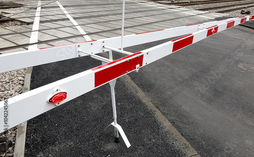 Level crossing red and white barrier.
