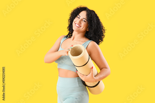 Sporty adult woman with yog...