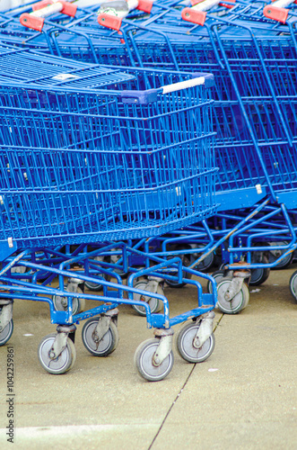 stacked blue supermarket shopping carts made of metal