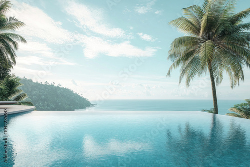 Palm trees surround a sparkling swimming pool with the ocean as a backdrop, creating a serene tropical oasis.