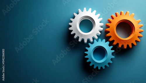 Three gears are shown on a blue background. The gears are orange and white. Concept of gears working together to create something