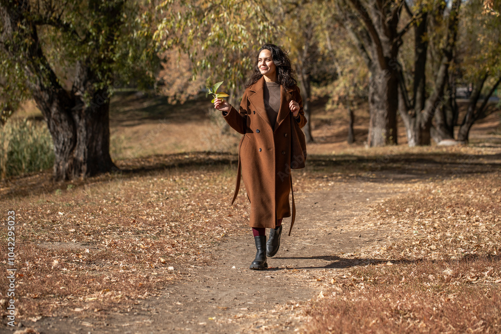 Beautiful middle aged woman walking in autumn park Beautiful middle aged woman walking in autumn park