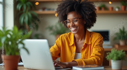 Happy black woman working home office with her laptop