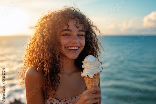 Teenage girl with curly hair, wearing a summer dress, eating an ice cream cone with the ocean in the background 1 photo