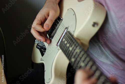 Man hands playing electric guitar. Jamming on guitar. Guitar strings close up.