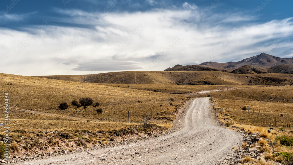 Fototapeta premium Dramatic clouds settle over the high mountain landscape