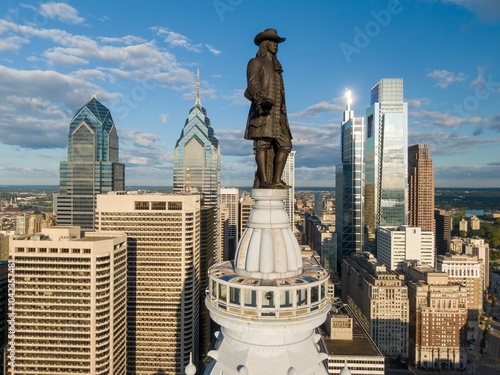 Statue of William Penn on top of  Philadelphia City Hall and the downtown city skyline of Philadelphia, Pennsylvania, United States. photo