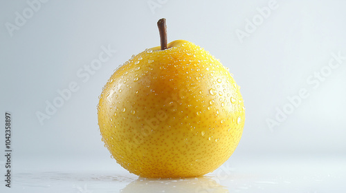 Whole nashi pear with water droplets on a light background for fresh fruit photography photo