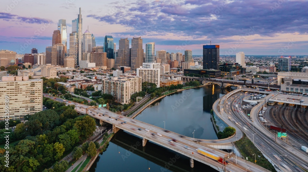 Traffic on the Vine St Expressway crossing the Schuylkill River and the downtown city skyline of Philadelphia at sunset, Pennsylvania, United States. Traffic on the Vine St Expressway crossing the Schuylkill River and the downtown city skyline of Philadelphia at sunset, Pennsylvania, United States.