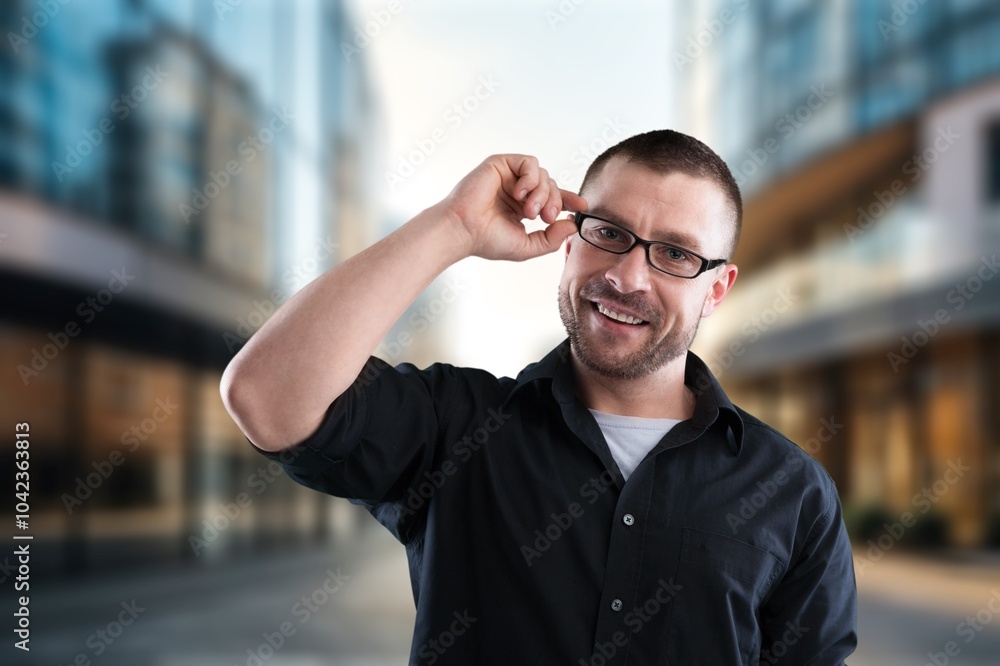 Young businessman posing outdoor at office building. Young businessman posing outdoor at office building.