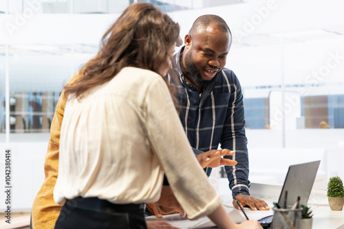 Corporate clients engage in office space planning session with a realtor, strategizing the layout and leasing terms for a high class urban workspace. Advises on investment opportunity relocation. photo