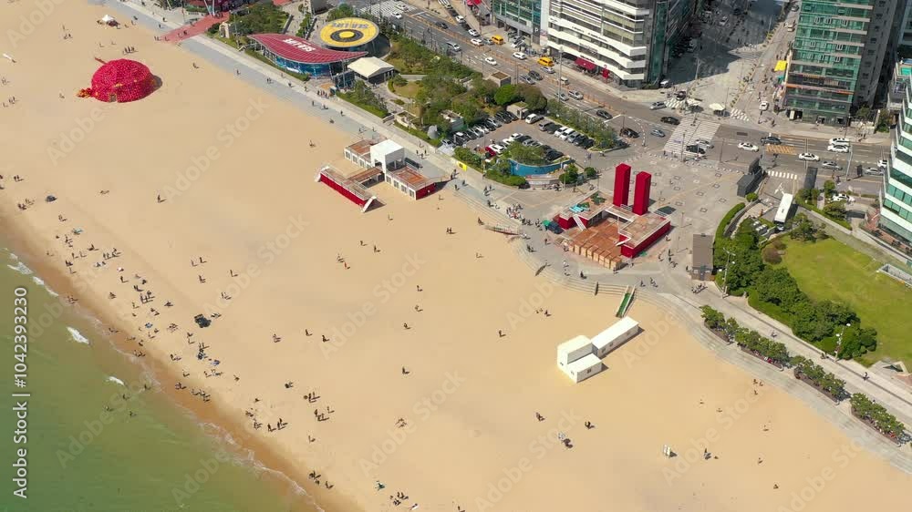 BUSAN, SOUTH KOREA - OCTOBER 19, 2024: Aerial view of Haeundae Beach showcasing visitors enjoying the sandy shore and beach activities in the city BUSAN, SOUTH KOREA - OCTOBER 19, 2024: Aerial view of Haeundae Beach showcasing visitors enjoying the sandy shore and beach activities in the city