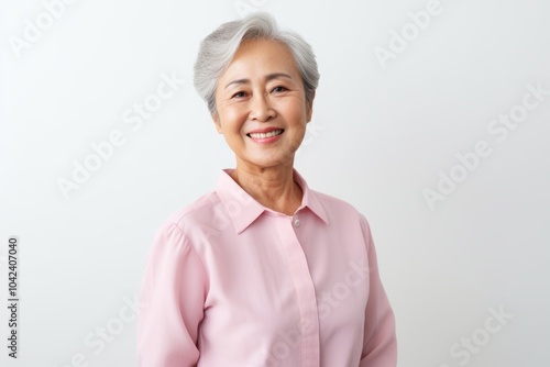 Portrait of happy asian senior woman with grey hair smiling at camera photo