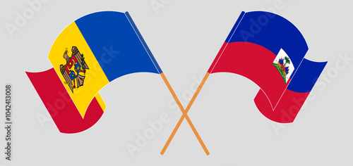 Crossed and waving flags of Moldova and Republic of Haiti. Vector illustration