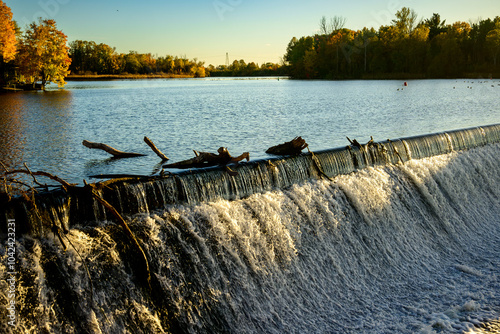 water flowing over a weir in autumn room for text shot at black's rapid on the historic rideau canal system outside ottawa photo