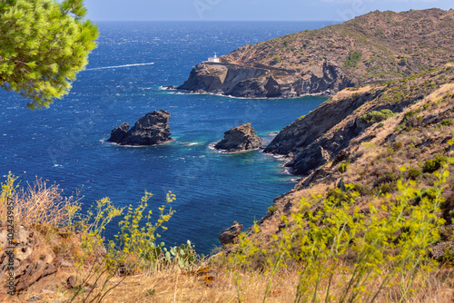 Cala Nans lighthouse on rocky coast, Cadaques, Spain photo