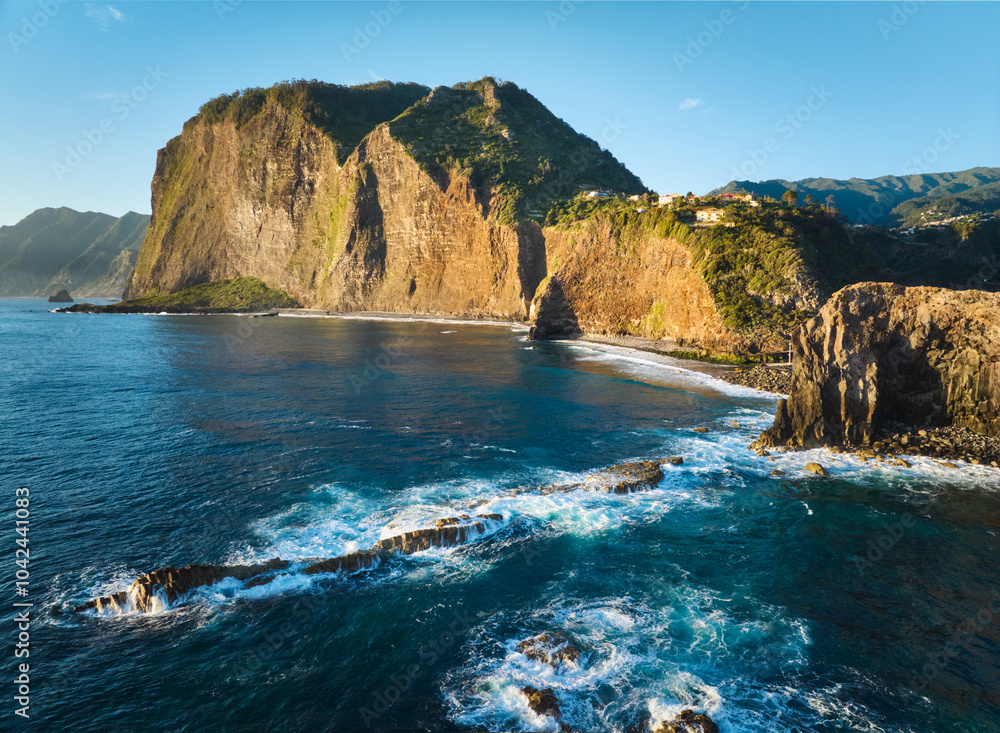 Obraz premium Aerial view of Madeira cliffs coastline landscape on sunrise, Guindaste viewpoint, Madeira island, Portugal