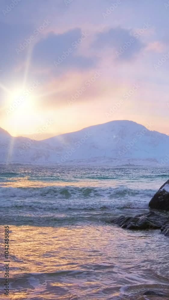 Beach of Norwegian sea on rocky coast in fjord on sunset. Skagsanden beach, Lofoten islands, Norway Beach of Norwegian sea on rocky coast in fjord on sunset. Skagsanden beach, Lofoten islands, Norway