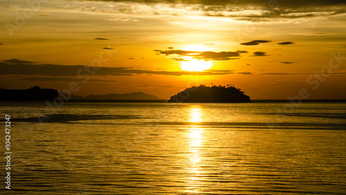 View of a golden sunrise on the island of Itacuruçá, in the Costa Verde region of southern Rio de Janeiro state.Moment of peace, reflection, and reenergization. photo