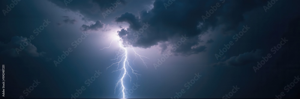 A dramatic lightning strike illuminates dark storm clouds, capturing the power of nature. Ideal for weather reports, environmental documentaries, and energy related themes. A dramatic lightning strike illuminates dark storm clouds, capturing the power of nature. Ideal for weather reports, environmental documentaries, and energy related themes.