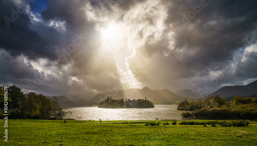 Derwentwater lake with dramatic sky and sunlight in Keswick. Lake District. England