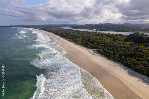 Aerial views of breaking waves crashing against Dreamtime beach in Fingal Head, New South Wales, Australia photo