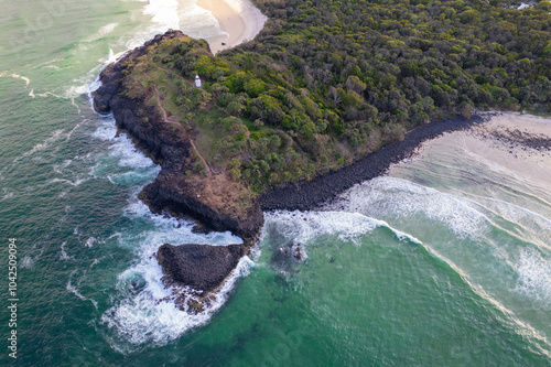 Aerial views of Fingal Head Lighthouse with the causeway rock formations below in Fingal Head, New South Wales, Australia photo