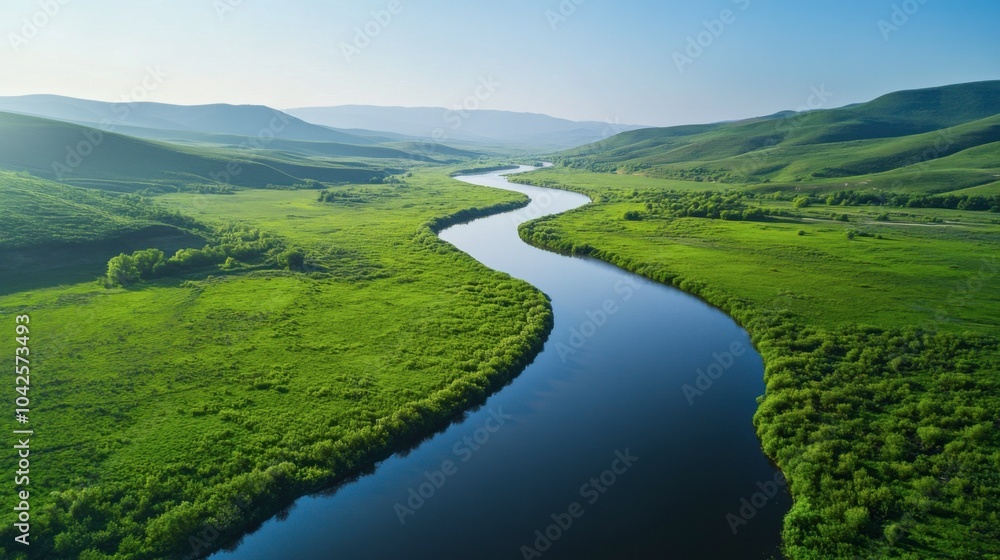 Experience the tranquility of a meandering river flowing through a lush valley, surrounded by rolling hills and majestic mountains, reflecting the clear blue sky in brilliant hues. Experience the tranquility of a meandering river flowing through a lush valley, surrounded by rolling hills and majestic mountains, reflecting the clear blue sky in brilliant hues.