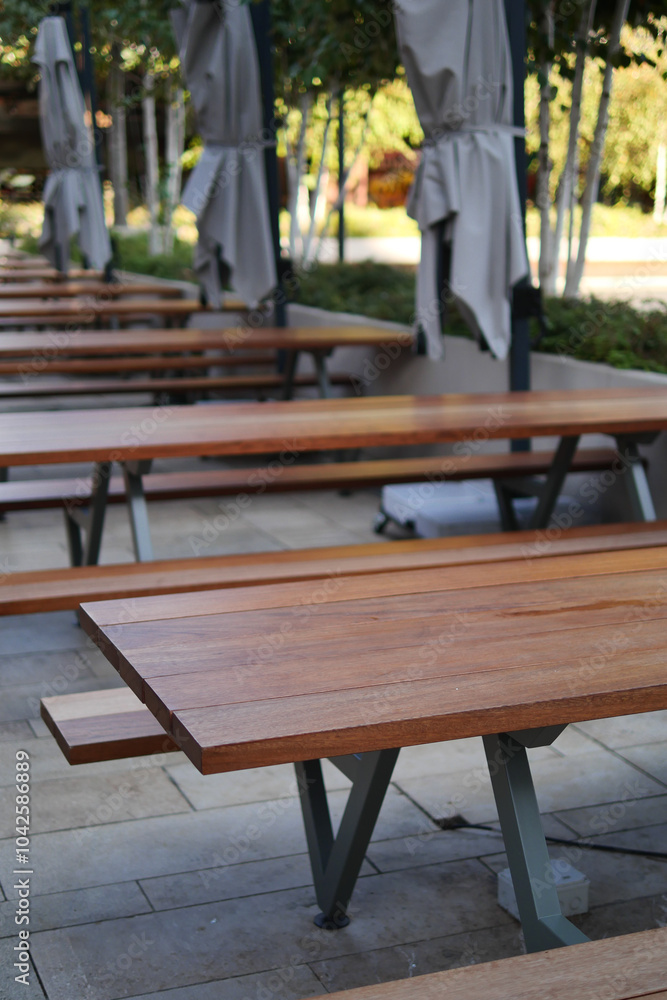 A Contemporary Wooden Outdoor Seating Arrangement Featuring Stylish Umbrellas for Shade A Contemporary Wooden Outdoor Seating Arrangement Featuring Stylish Umbrellas for Shade