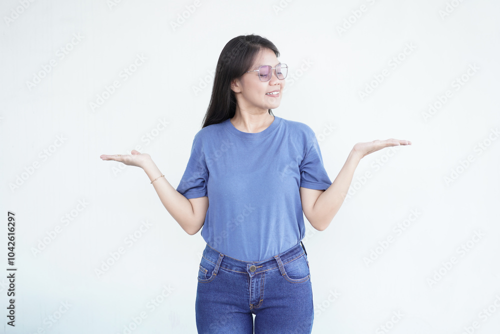 Beautiful Asian woman smiles warmly while displaying a product in her open palms against a white background Beautiful Asian woman smiles warmly while displaying a product in her open palms against a white background