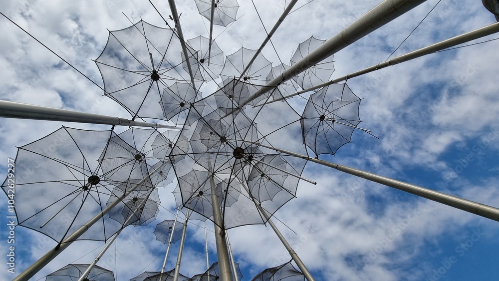 Obraz premium salonica umbrellas metallic street art sea fountain rain cloudy sky greece