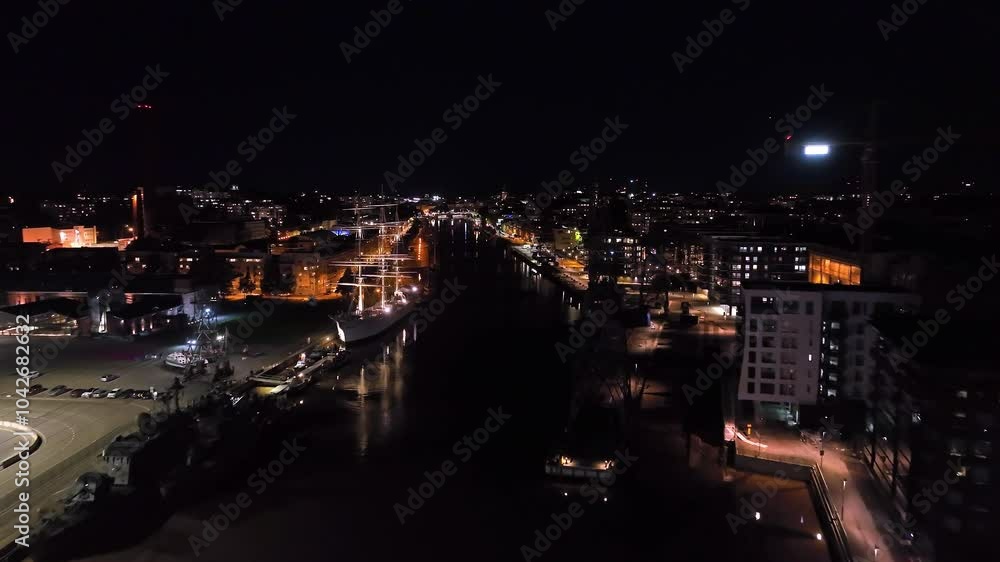 Drone flyover the night lit Aura river, serene evening in Turku, Proper Finland Drone flyover the night lit Aura river, serene evening in Turku, Proper Finland