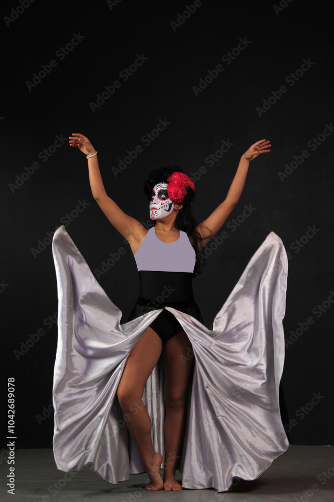 Mexican teenage woman with catrina makeup and does dancer steps to celebrate the Day of the Dead in Mexico Mexican teenage woman with catrina makeup and does dancer steps to celebrate the Day of the Dead in Mexico