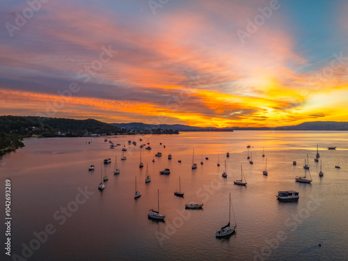 Aerial sunrise waterscape with boats and high cloud photo