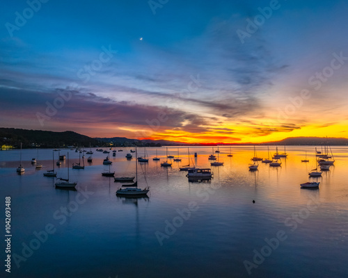 Aerial sunrise waterscape with boats and high cloud photo