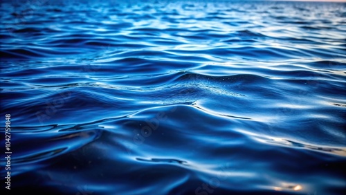 Dark blue water surface with subtle waves close up