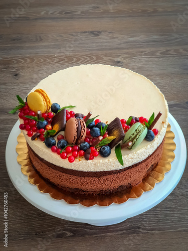 Chocolate sponge cake with dark chocolate mousee, whiskey cream mousse, sour cherries jelly and mascarpone cream frosting. Selective focus. photo