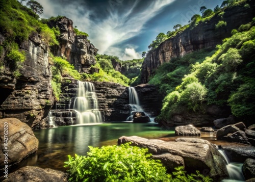 Breathtaking Waterfalls Cascading Through Verdant Forests at the Base of Majestic Rock Cliffs