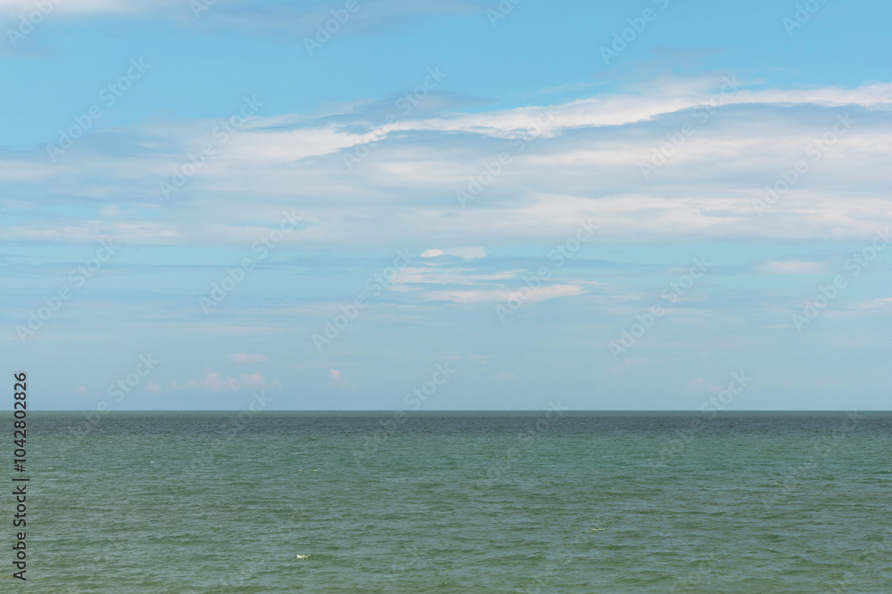 Serene seascape with calm ocean waters meeting a clear blue sky. The horizon line blends smoothly, creating a peaceful and tranquil natural scene. Perfect for backgrounds, travel, and nature. Serene seascape with calm ocean waters meeting a clear blue sky. The horizon line blends smoothly, creating a peaceful and tranquil natural scene. Perfect for backgrounds, travel, and nature.