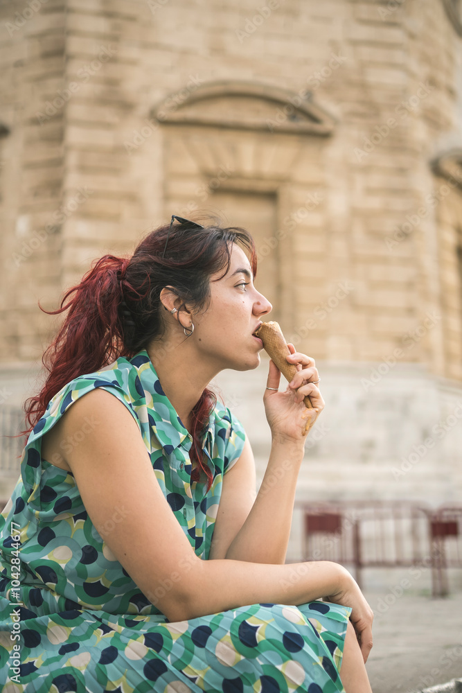 Fototapeta premium middle aged redhead woman eating ice cream