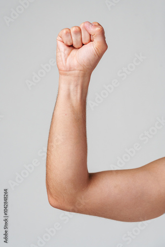 A person hand gesture against a neutral background