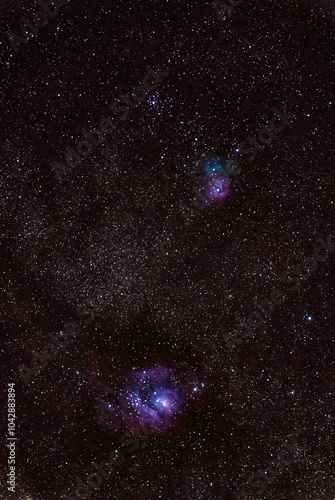 Milky way Lagoon and Trifid nebulae photographed through a long focal telescope. photo